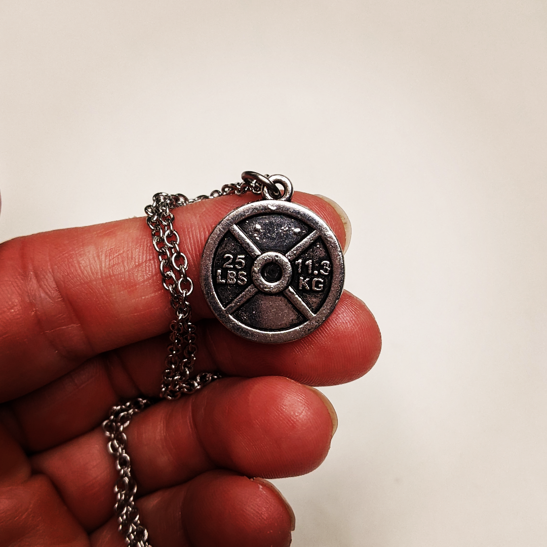 necklace with a weight plate charm this shows 25 lbs on it