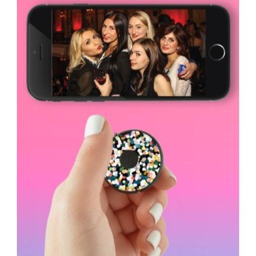 Girls taking a photo together using the Clickie Self Remote technology tool that allows you to take remote photos.