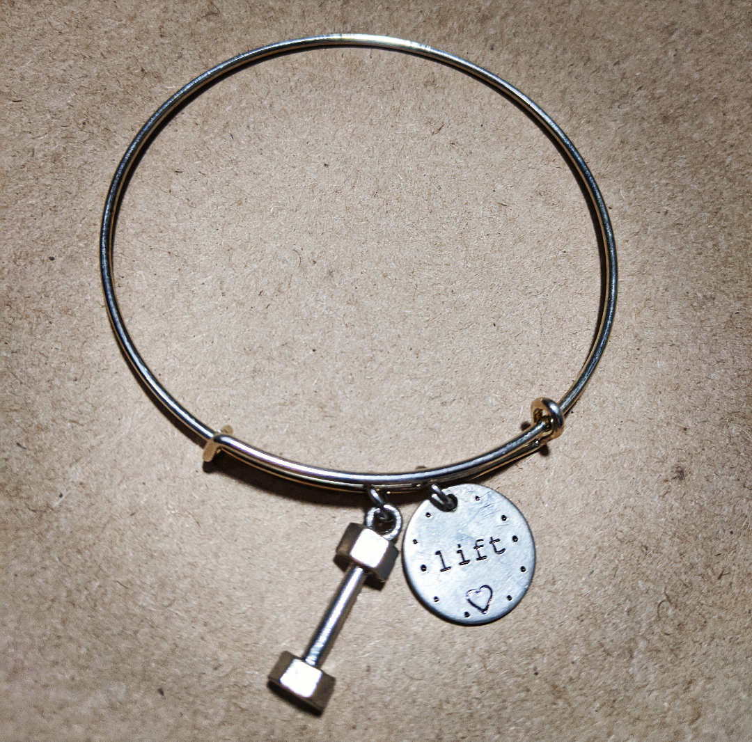 Stainless Steel bracelet with a dumbell charm and a charm that says live with a heart on it
