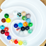 Colourful Marbles on a white Dish