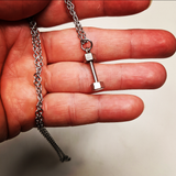 Necklace with a mini dumbbell charm on it